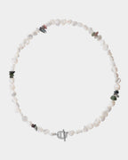 Collar con cuentas blancas y pequeñas piedras de colores sobre un fondo blanco