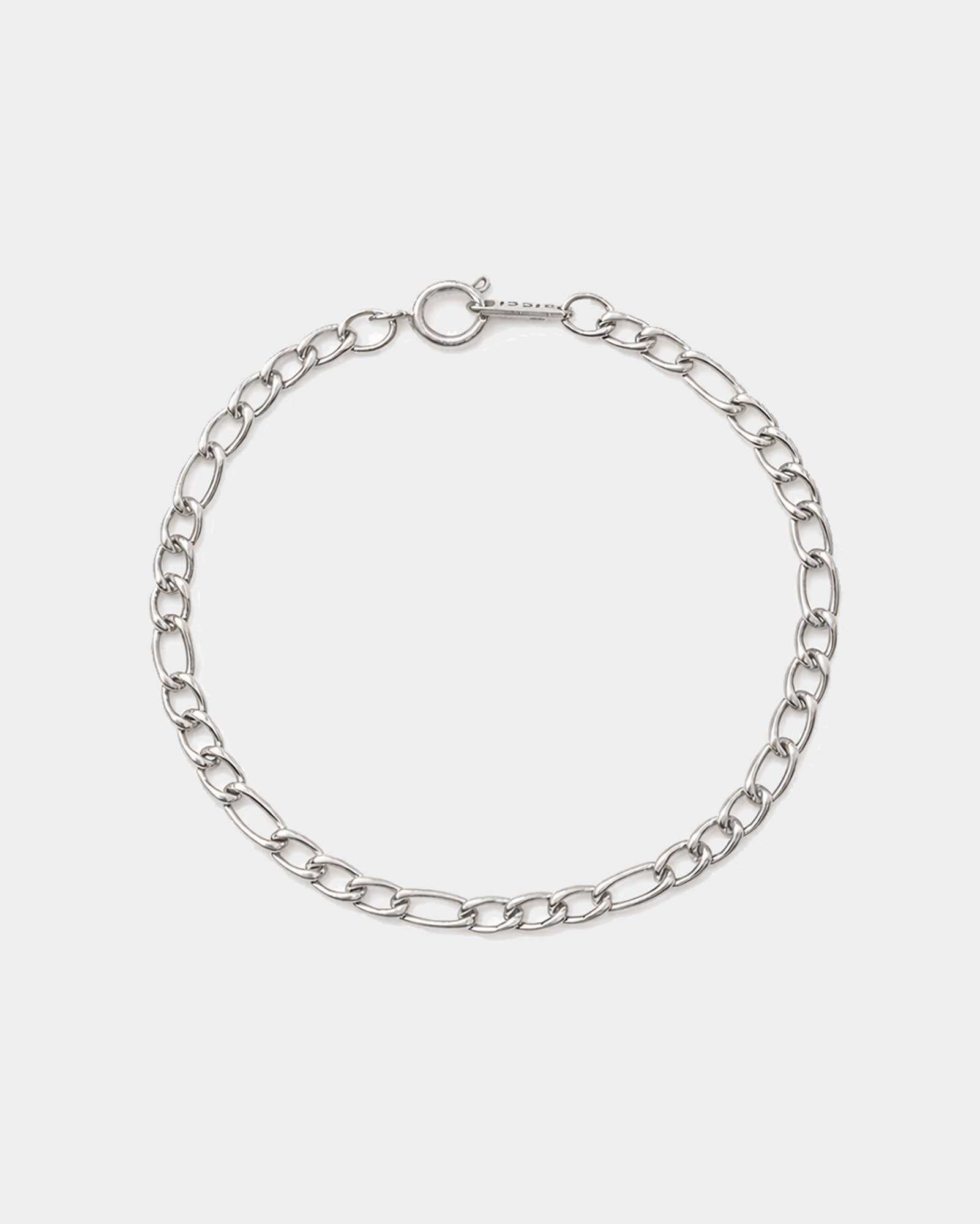 Silver chain bracelet on a light gray background