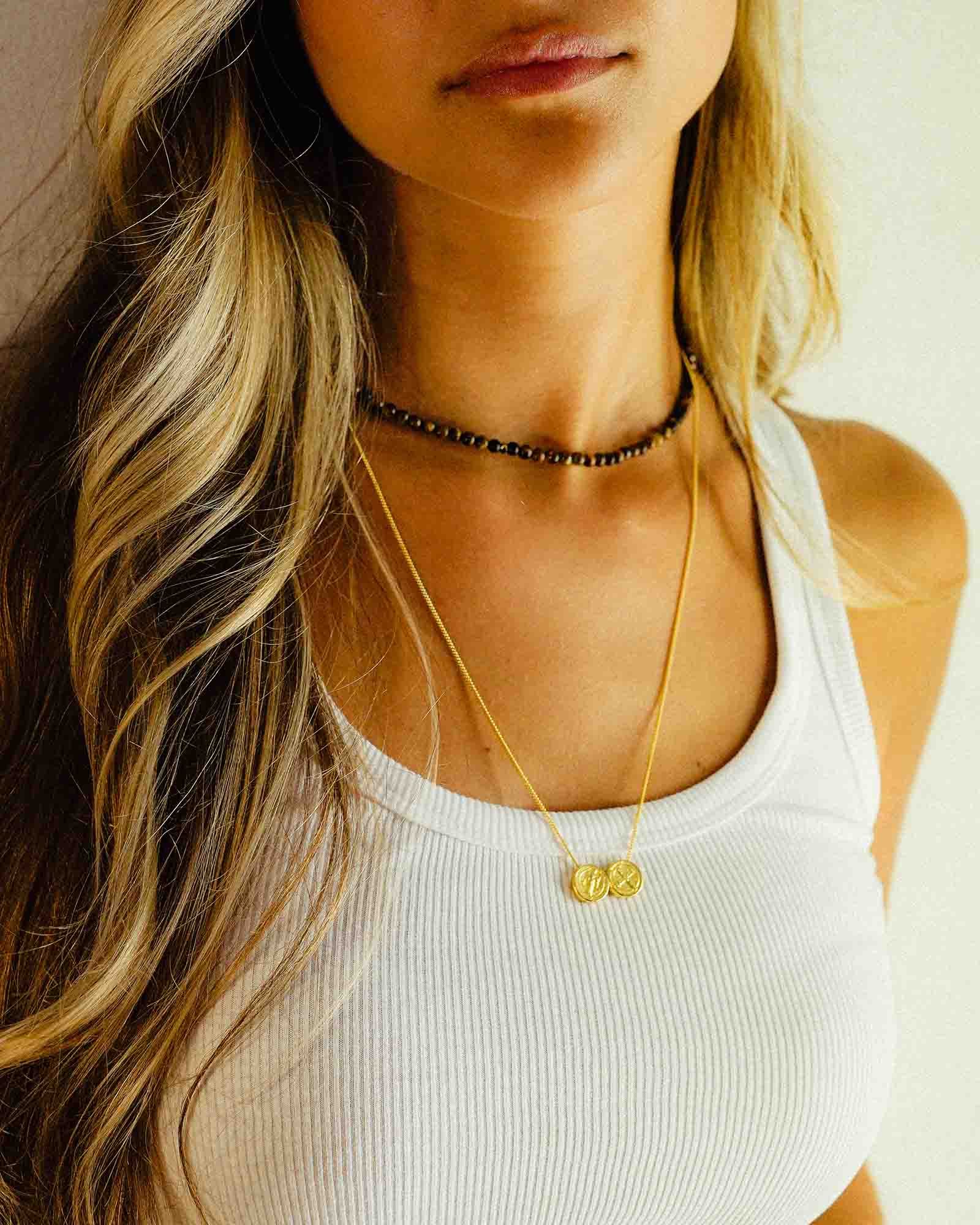 Model wearing golden St. Benedicts scapular