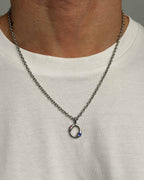 Necklace with a pendant worn by a person on a plain background