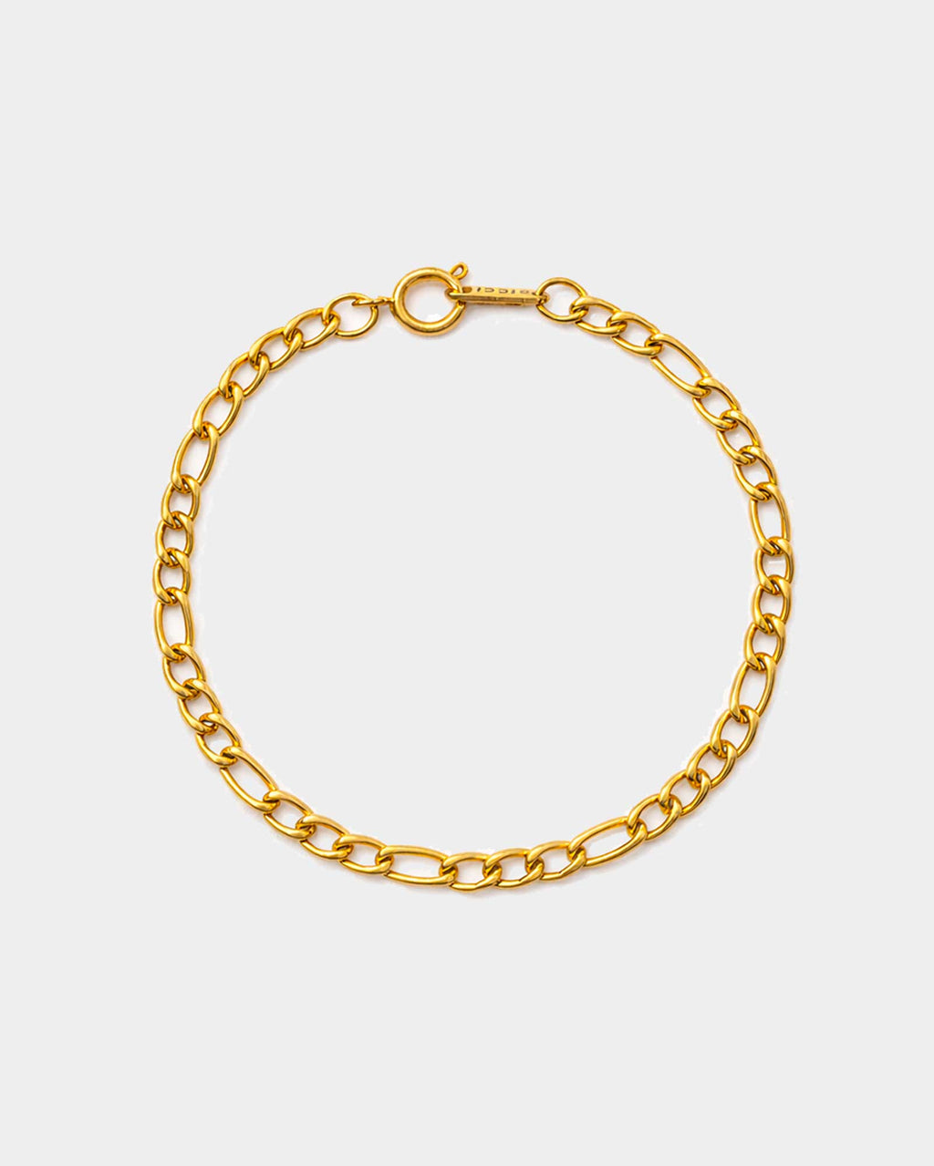 Gold chain bracelet on a light gray background