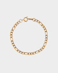 Gold chain bracelet on a light gray background