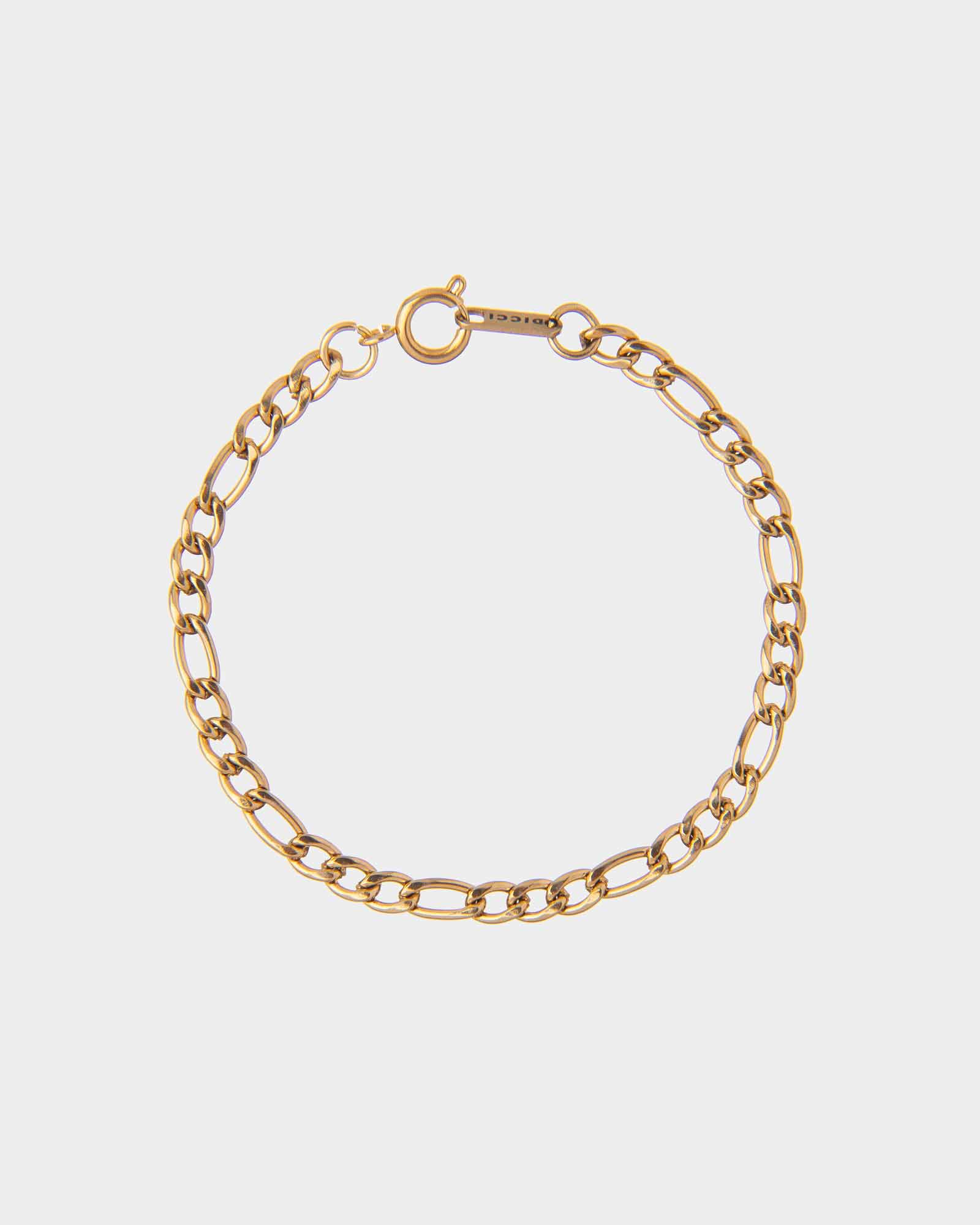 Gold chain bracelet on a light gray background