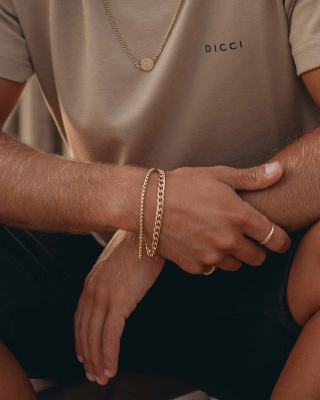 Golden flat cuban chain bracelet on wrist