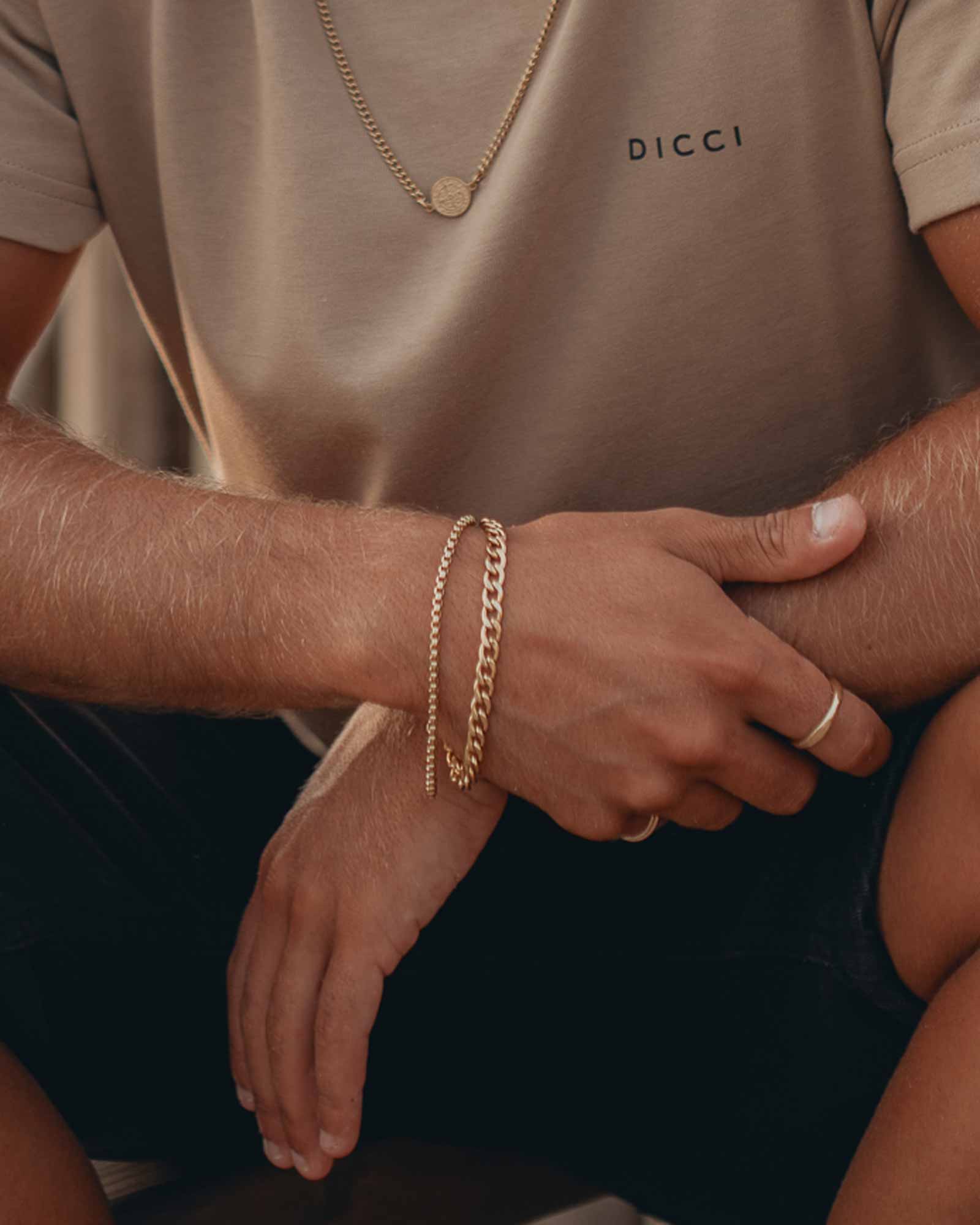 Golden flat cuban chain bracelet on wrist