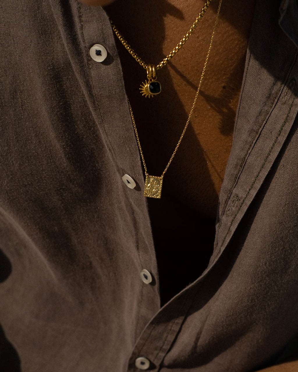 Do Carmo Golden Scapular with pendant worn by a person