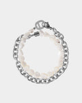 Bracelet with white beads and silver chain on a light gray background