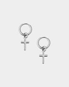 A pair of silver hoop earrings with small cross charms, displayed on a light gray background.