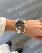 Automatic Watch Limited worn on wrist on a neutral background