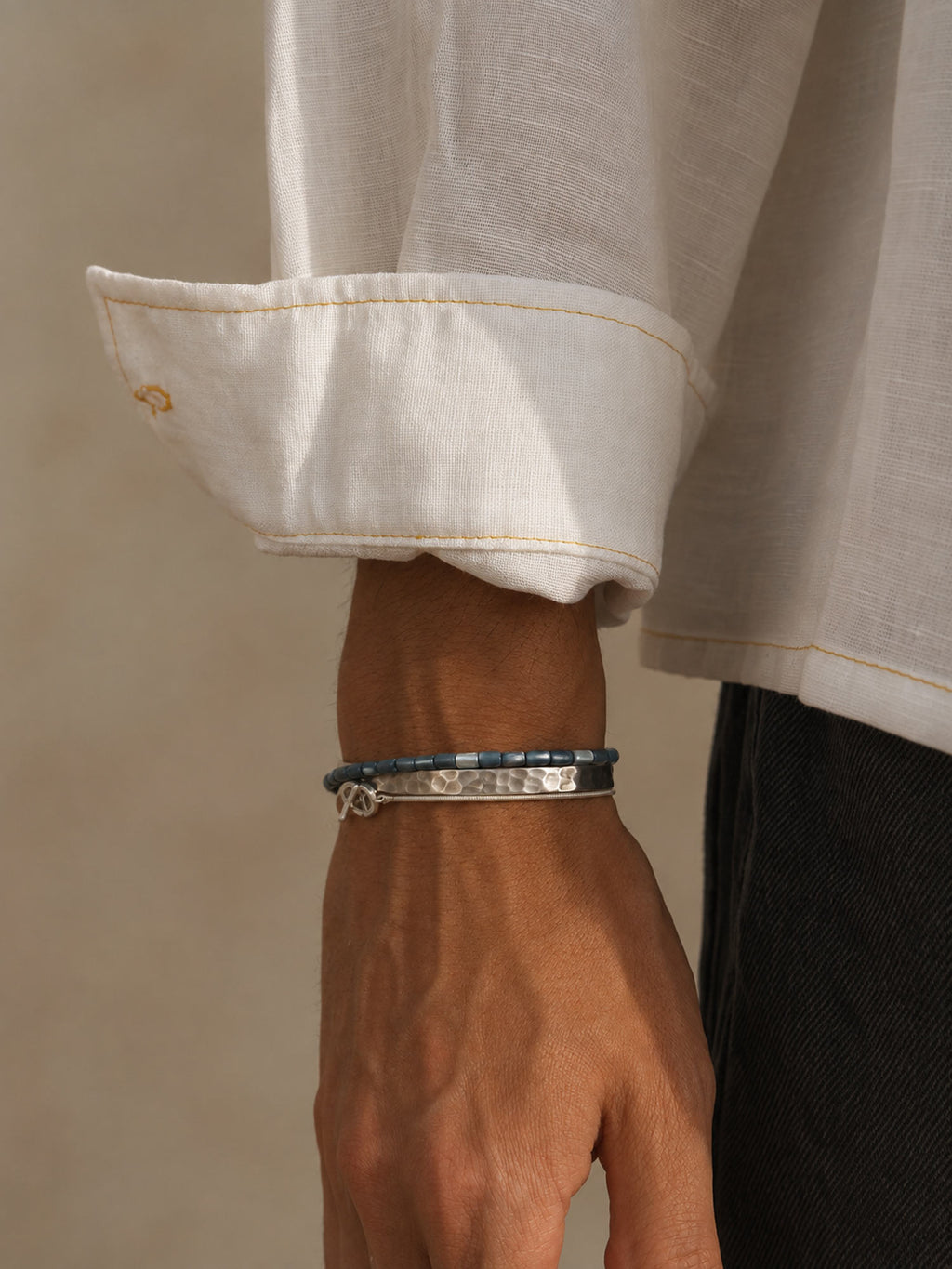 men wearing blue shell bracelet and other silver bracelets