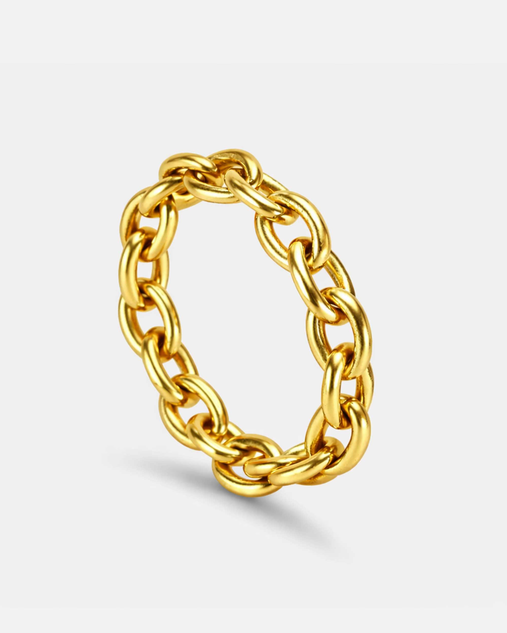 Golden cable ring in stainless steel on a white background