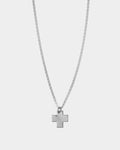 Silver cross necklace on a light gray background