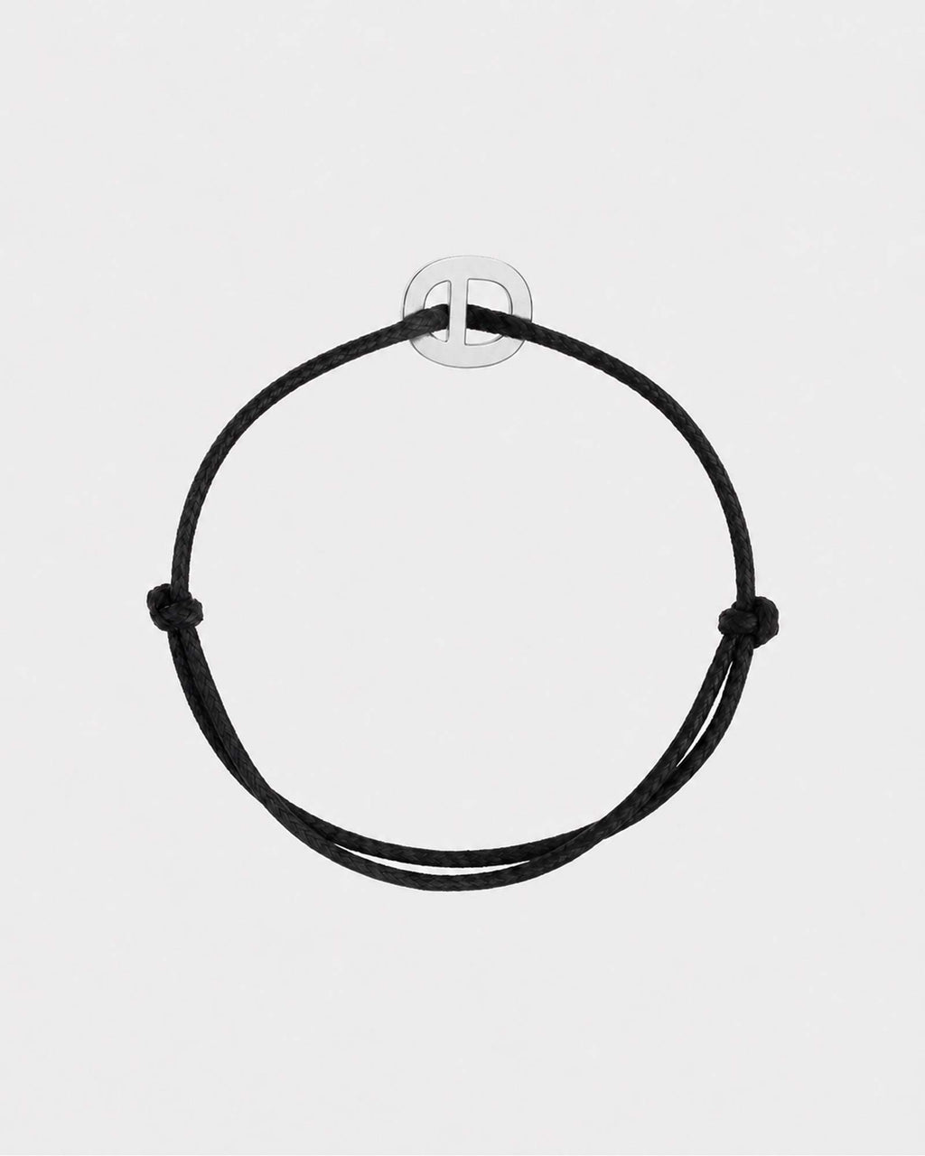 Black cord bracelet on a light gray background