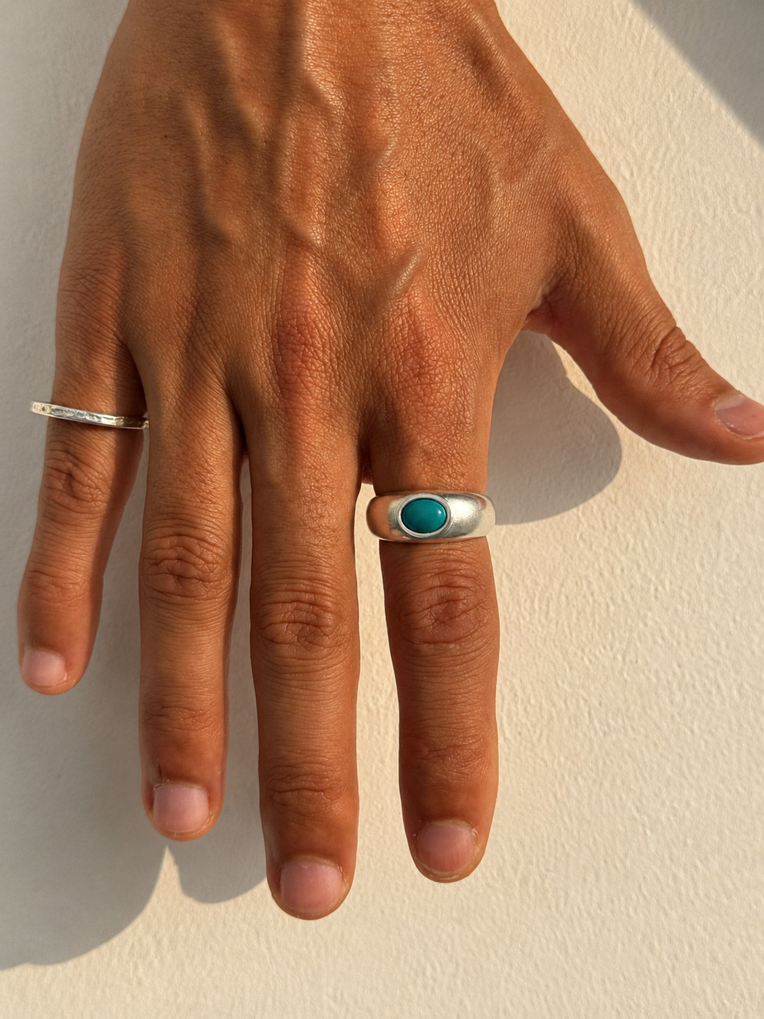 man wearing turquoise silver ring