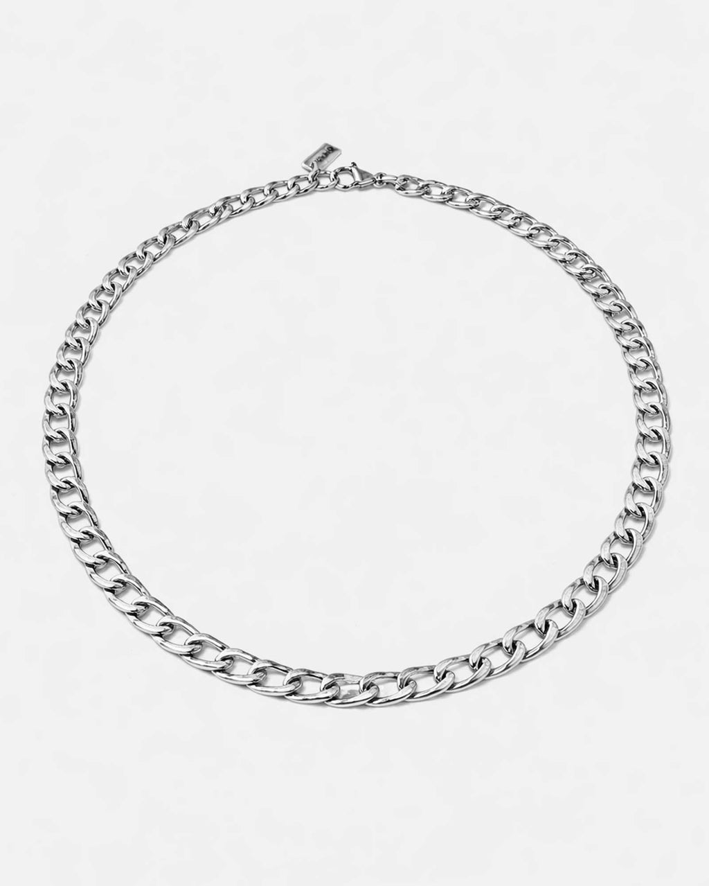 Silver chain necklace on a light gray background