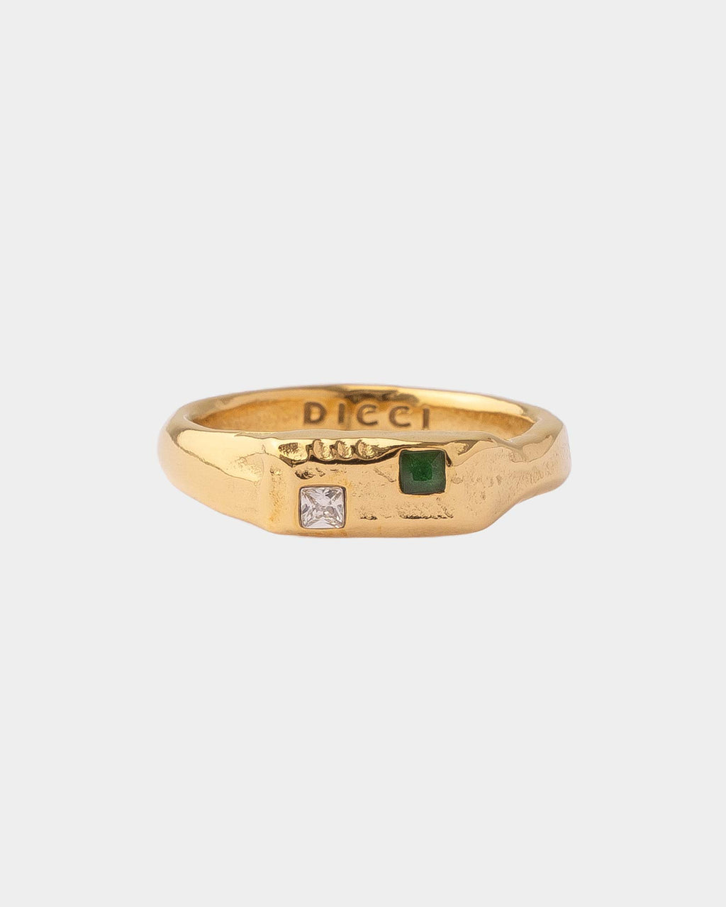 Gold ring with embedded gemstones on a white background