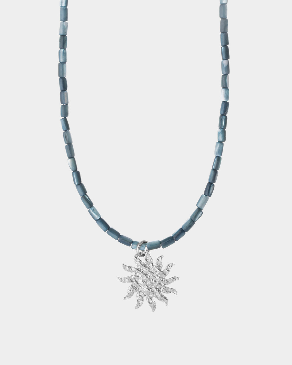 helios necklace on light silver background