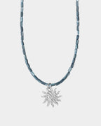 helios necklace on light silver background