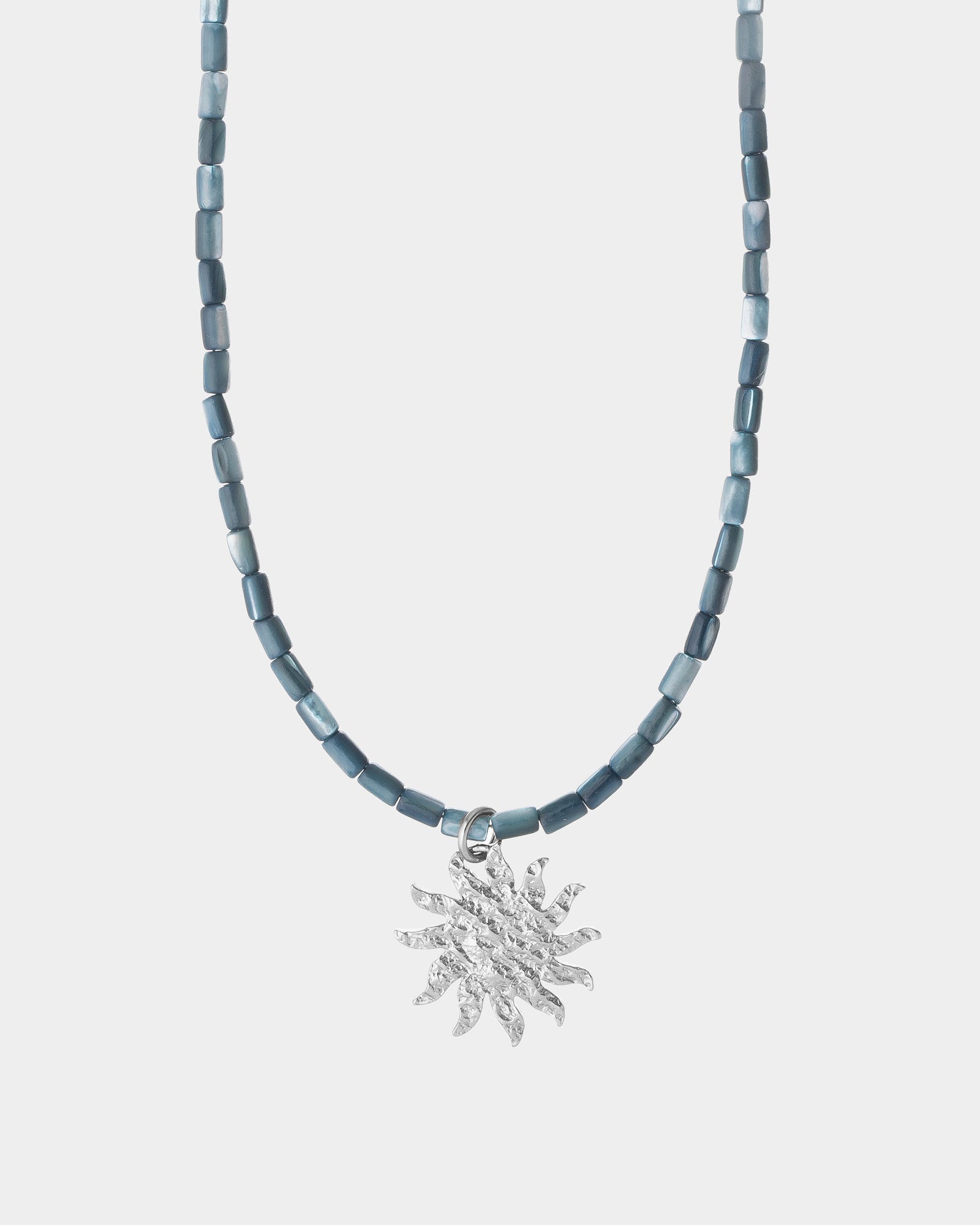helios necklace on light silver background