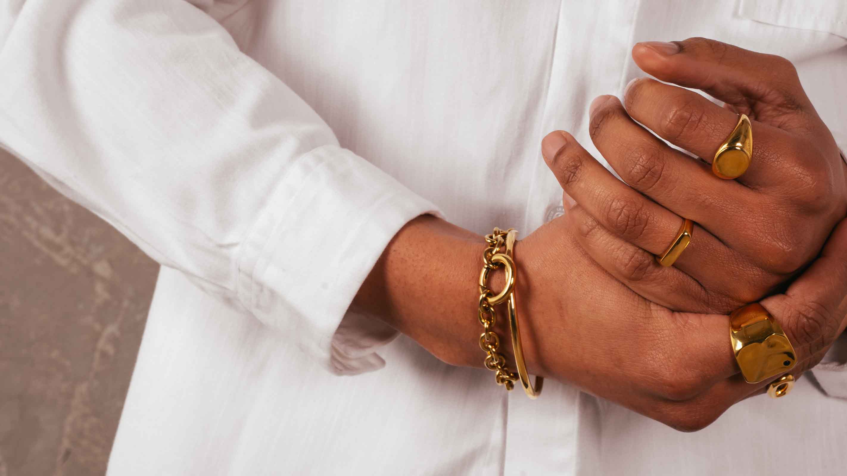 men wearing golden jewelry with natural stones