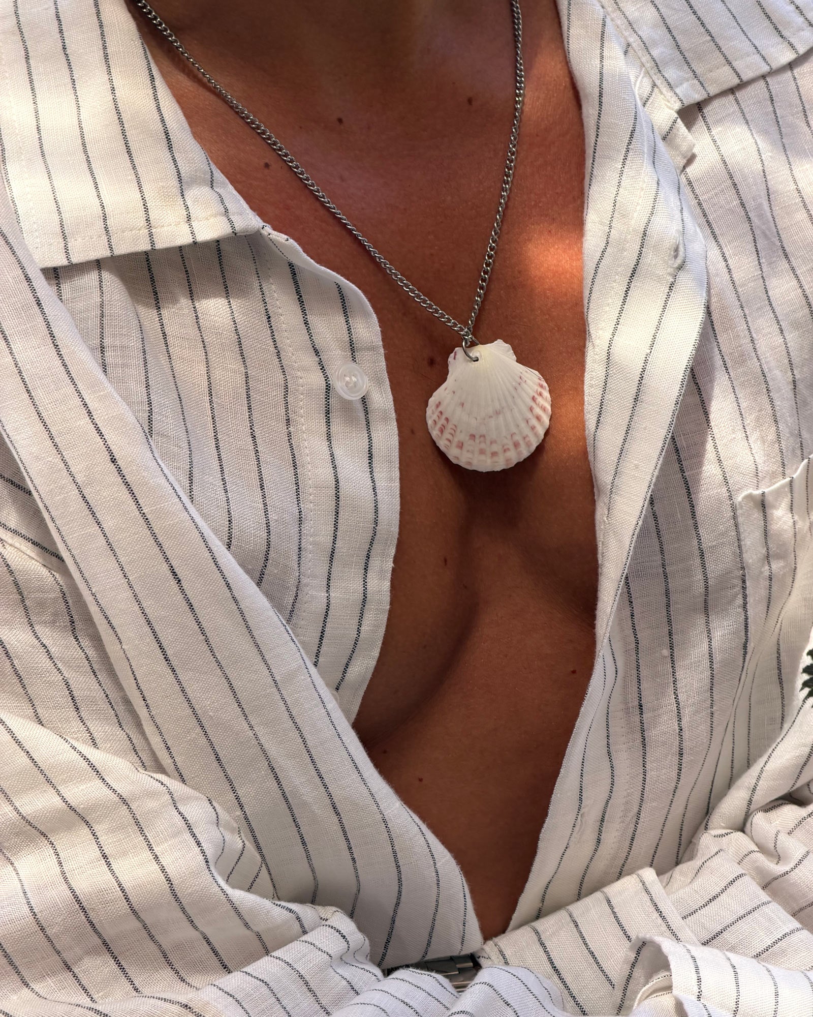 men wearing shell necklace