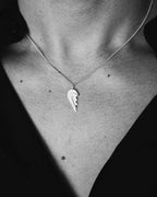 Other Half necklace in 925 silver worn by model on a neutral background