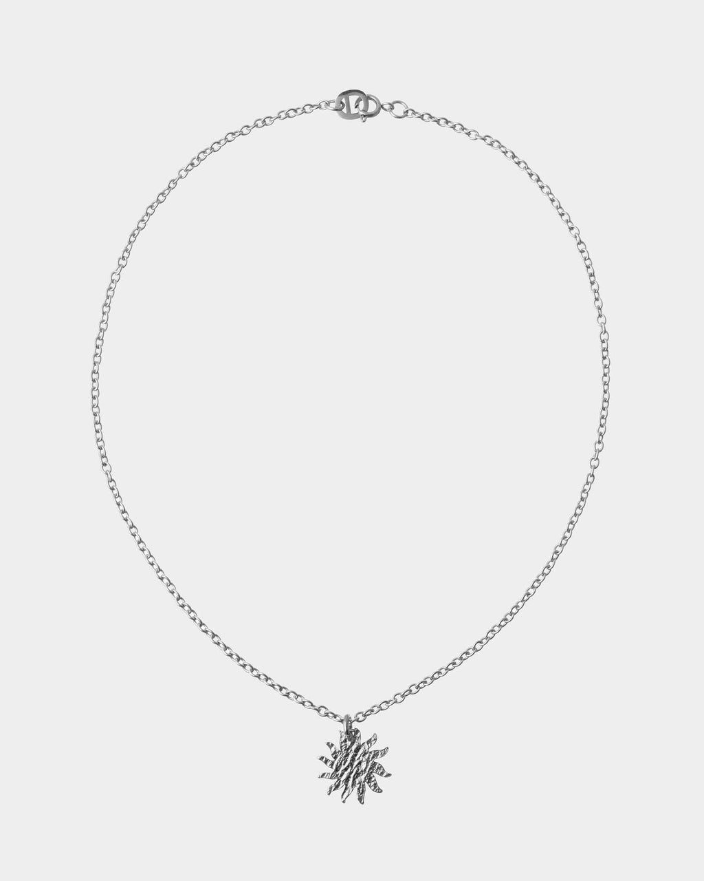 Silver necklace with a snowflake pendant on a light gray background