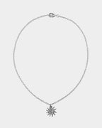 Silver necklace with a snowflake pendant on a light gray background