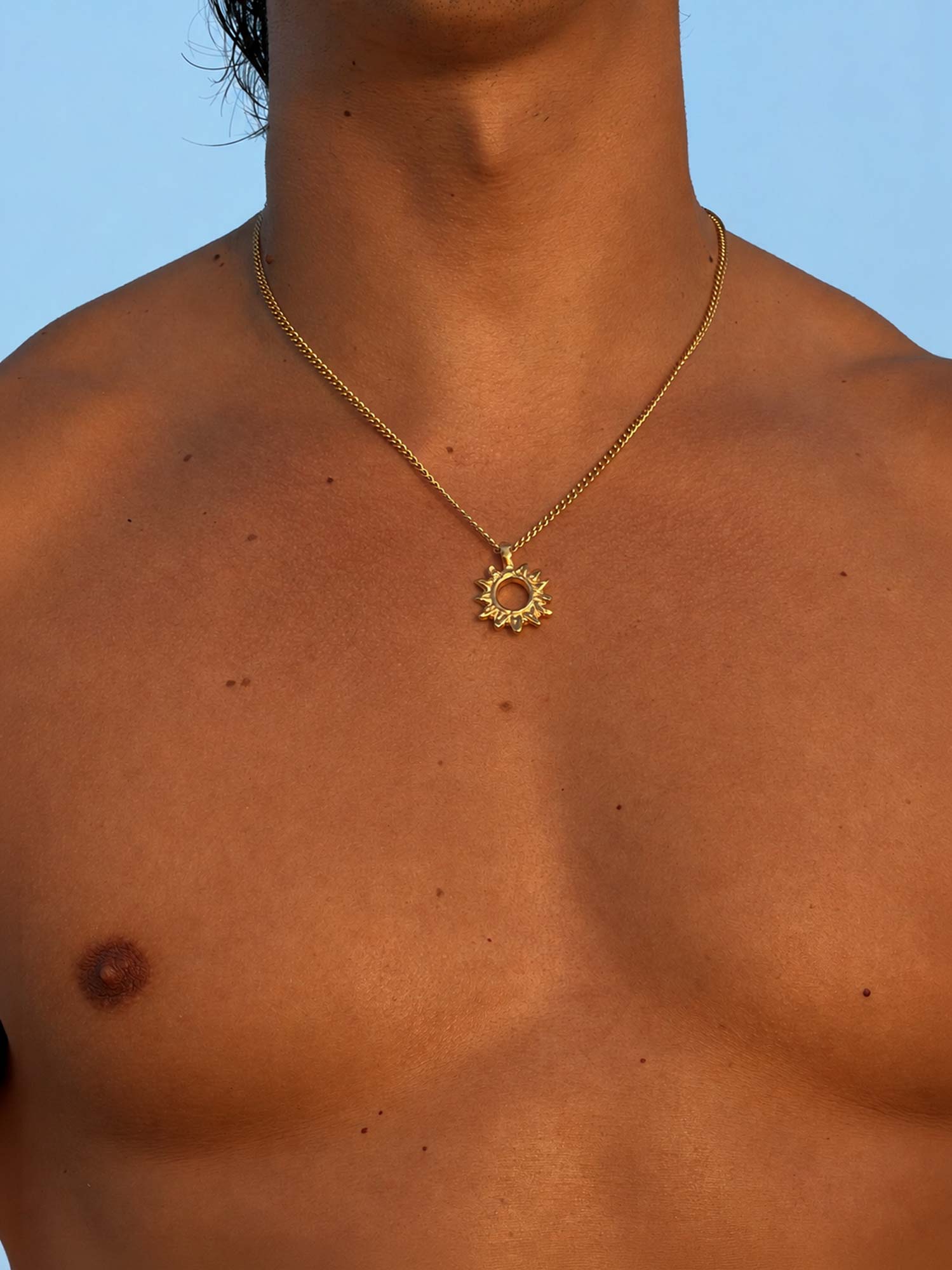 men wearing sunburst gold necklace