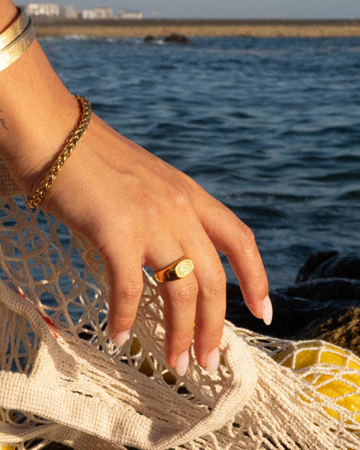 golden sunray ring in stainless steel on a neutral background