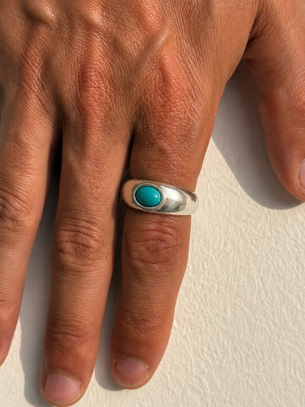 hand with silver turquoise ring