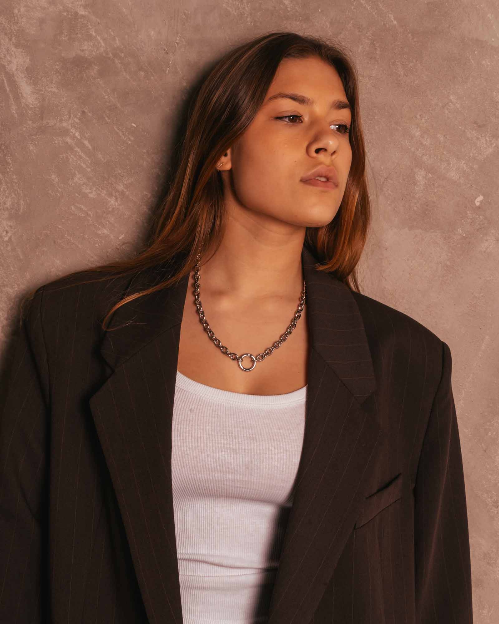 women wearing silver ring necklace