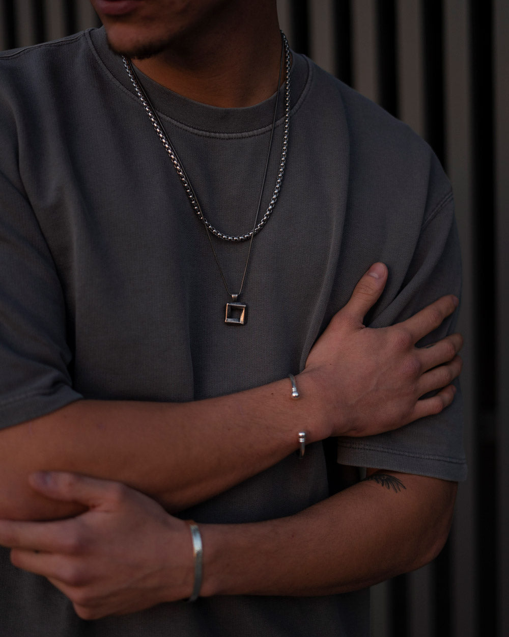 Silver 4mm Rolo Chain Necklace made of 316L stainless steel worn with pendant and bracelets