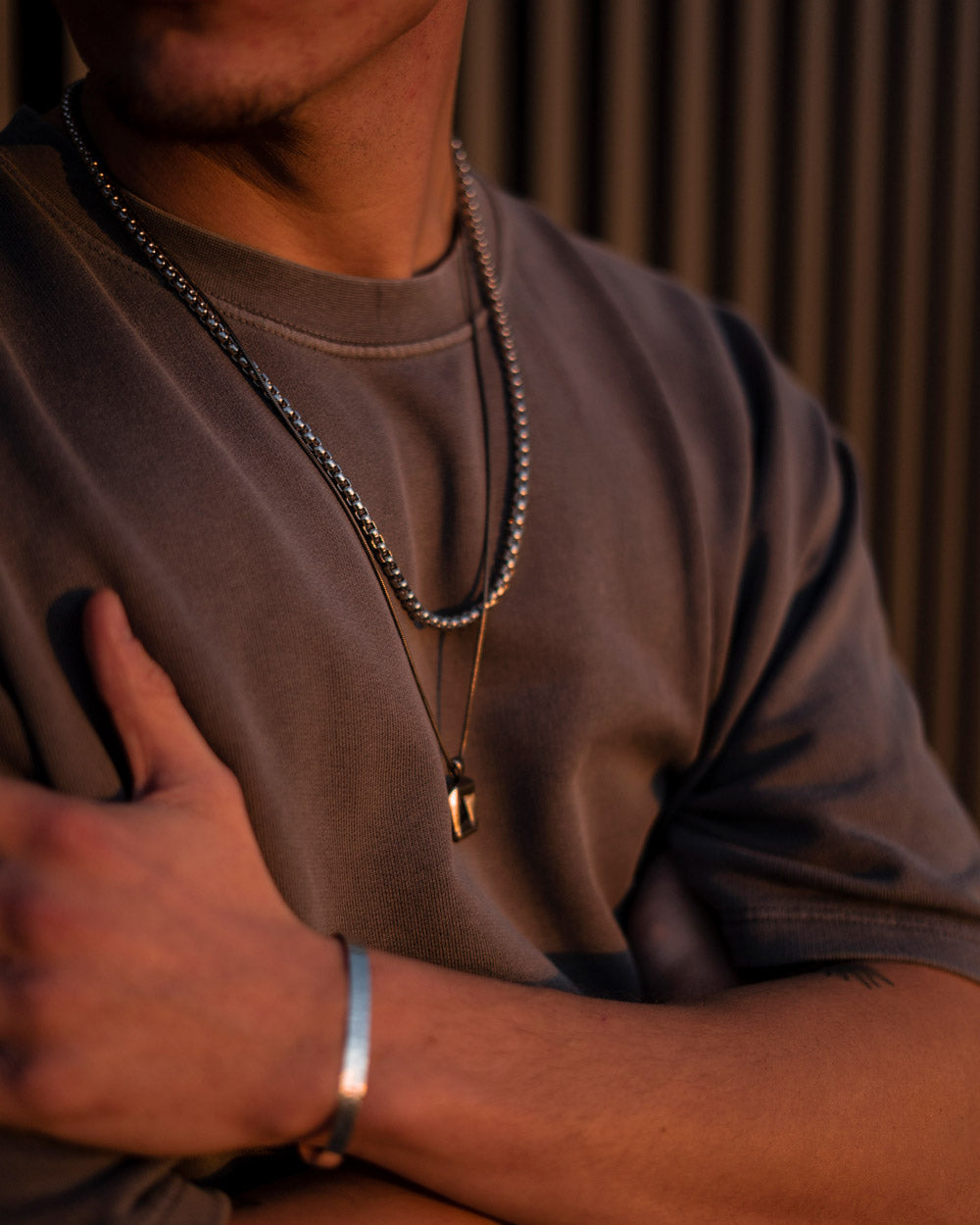 Silver 4mm Rolo chain necklace worn with pendant on casual outfit