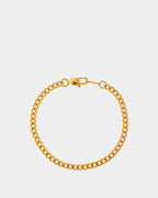 Golden Cuban chain bracelet in stainless steel on a white background