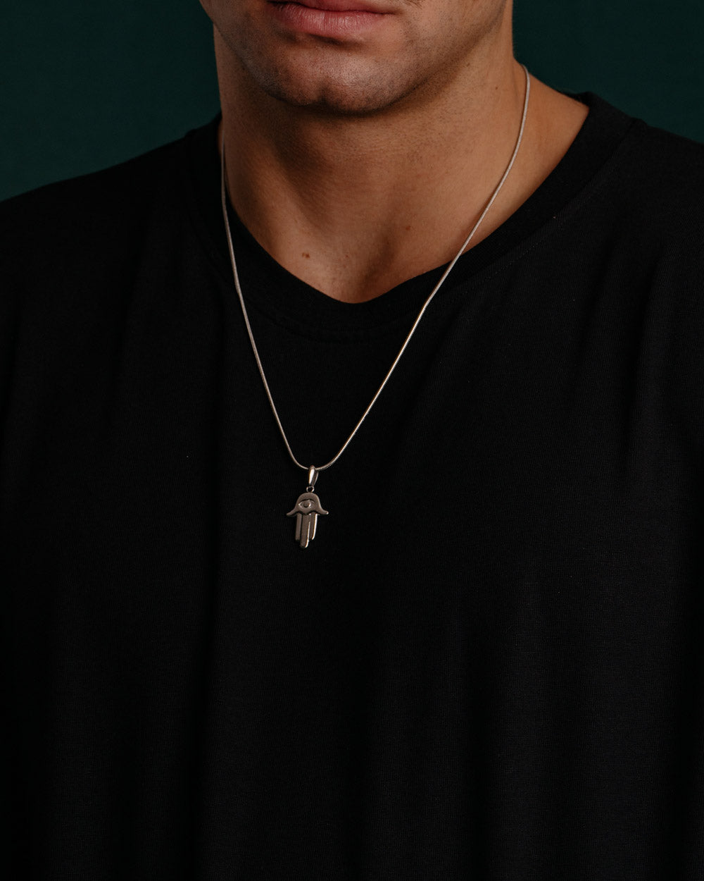 Minimalist Hamsa - Stainless Steel Necklace on the models neck - online unissex Jewelry - Dicci