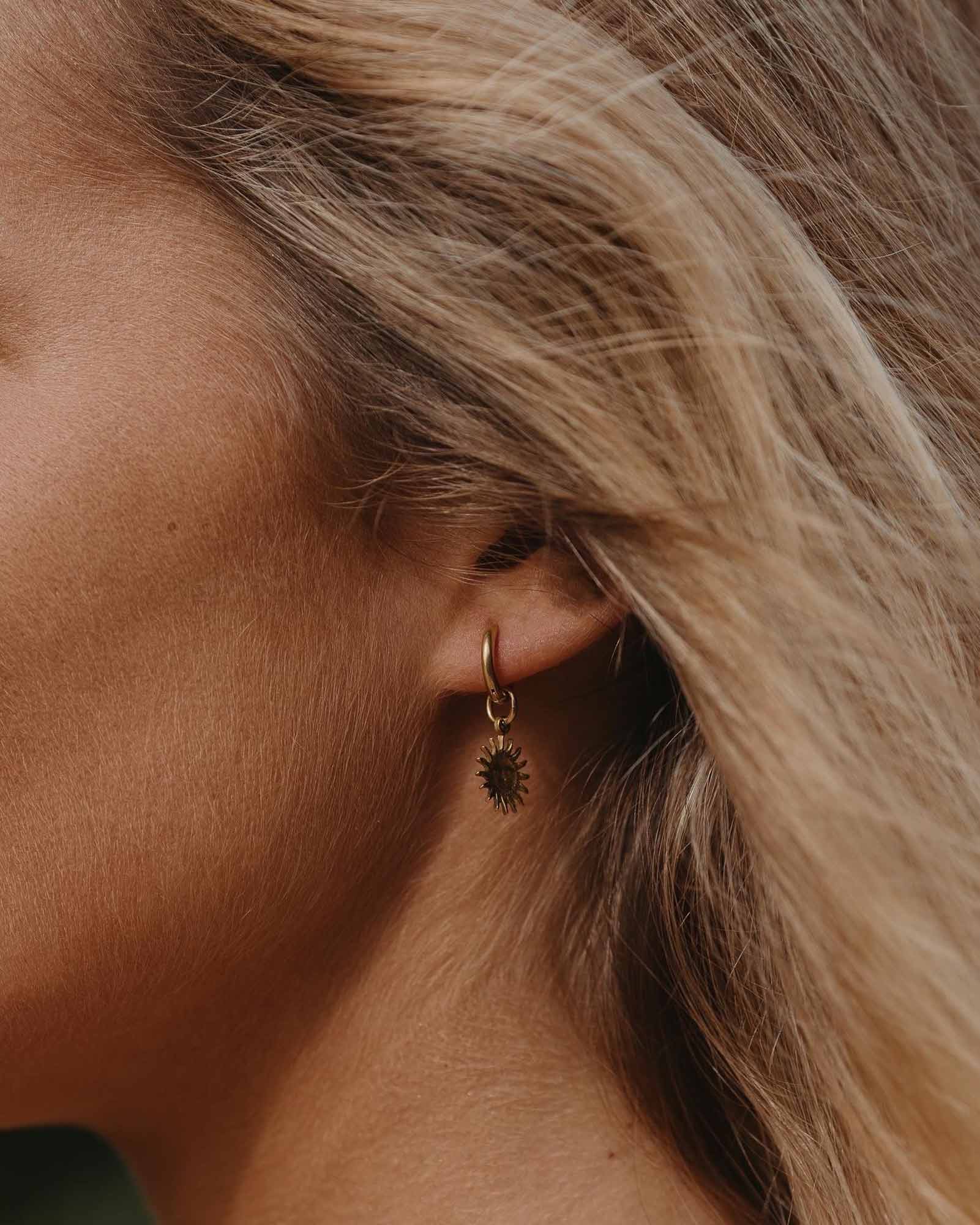 Golden Stainless Steel Earring Sun on the models ear - Golden Earring - Online Unissex Jewelry - Dicci